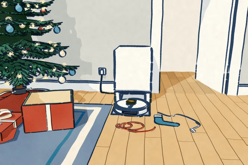 The morning after: a white robot vacuum on its dock against the wall, its cord to the socket. A curl of ribbon, a sock and a loose phone cable lie on the floor ahead of it, and a door stands open to the next room.