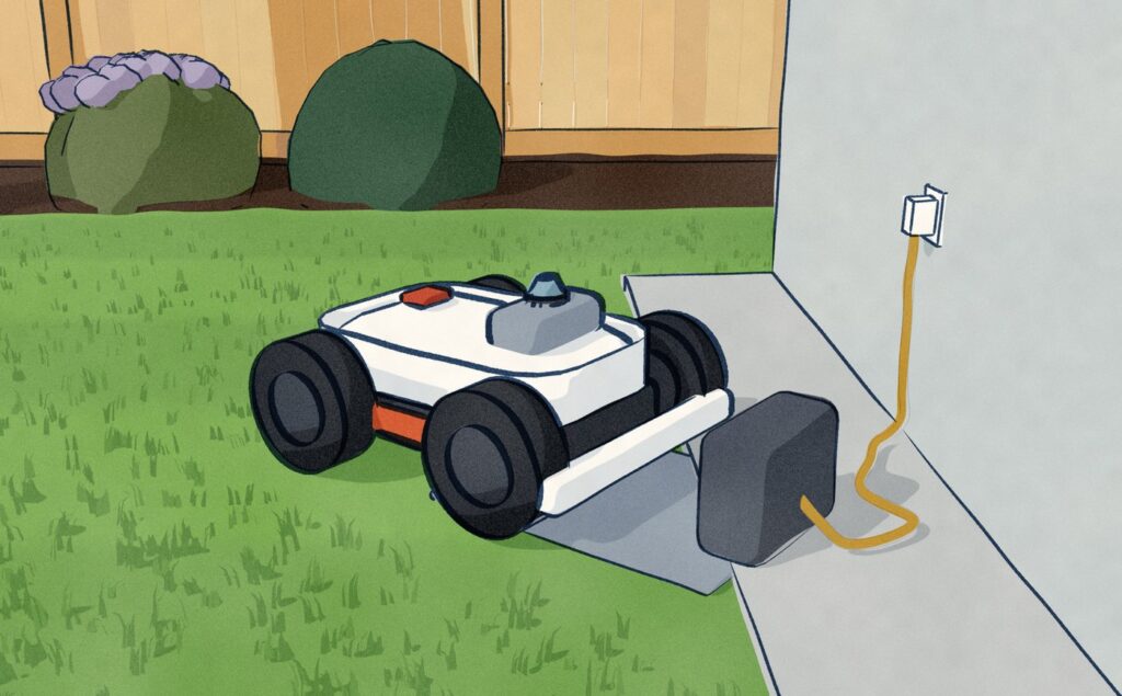 A white wire-free robot mower charges on its station at the foot of a garden-room wall, the station's one power lead running across the gravel to the outdoor socket, and nothing laid in the lawn.