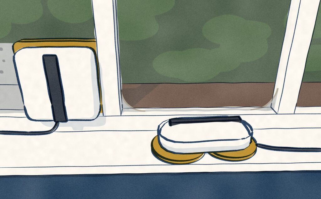 The R3 has been lifted off and laid on the sill below the round pockets of dust its round pads left in the corners of its pane, while the 2S beside it works square into its own corner.