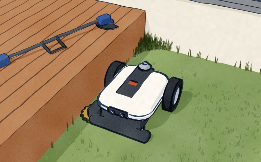 Low on a lawn where a white garden wall turns a corner: the white Ecovacs Goat A3000 drives back out along the wall with its built-in edge trimmer at the foot of the wall, and behind it a wedge of long grass still stands in the corner the round trimmer could not reach.