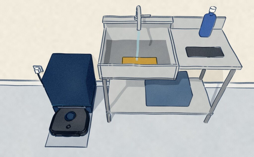 The Bissell sits in its navy base, which only empties the bin, while its mop pad lies in a steel sink under the running tap beside its bottle of cleaning formula.
