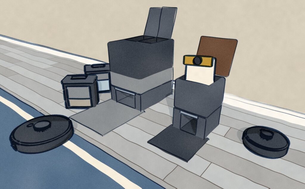 The two docks opened for service at floor level: the Roborock Qrevo S Pro tower has both lids up and its clean and dirty water tanks stand on the floor beside it, while the SwitchBot K11+ dock has its wood lid raised and its dust bag lifted half out; both robots wait out on the floor.