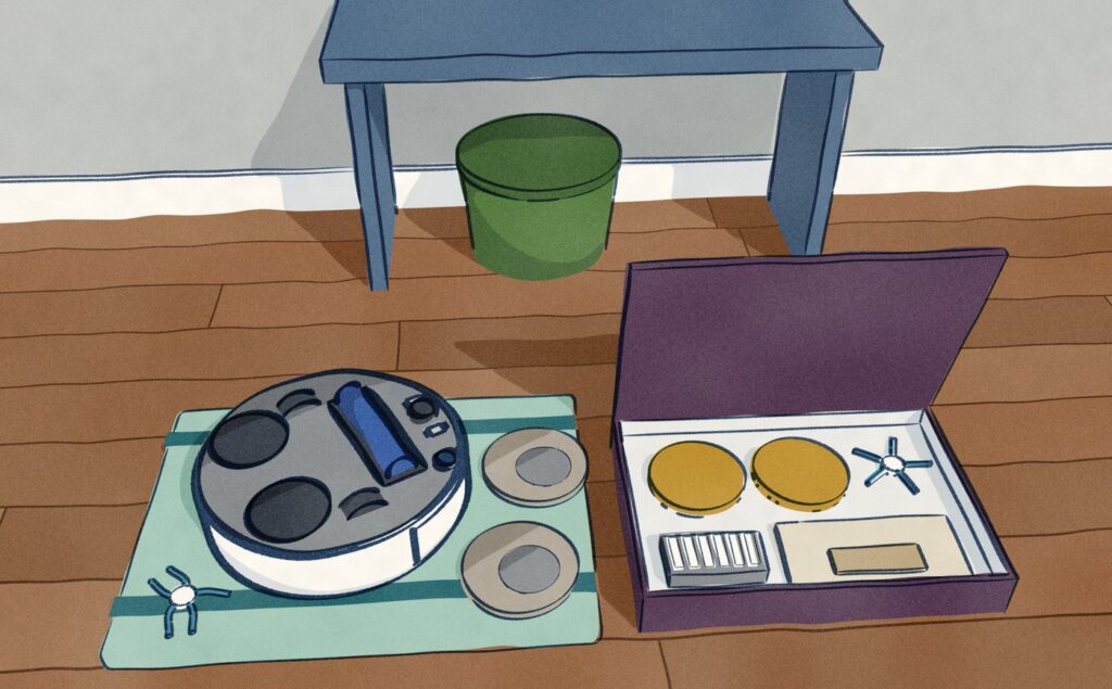 The Narwal robot vacuum lies on its back on a folded towel on the hall floor in front of the bench, its worn mop pads and side brush taken off beside it, next to an open parts kit holding fresh pads, a side brush, a filter and a dust bag.