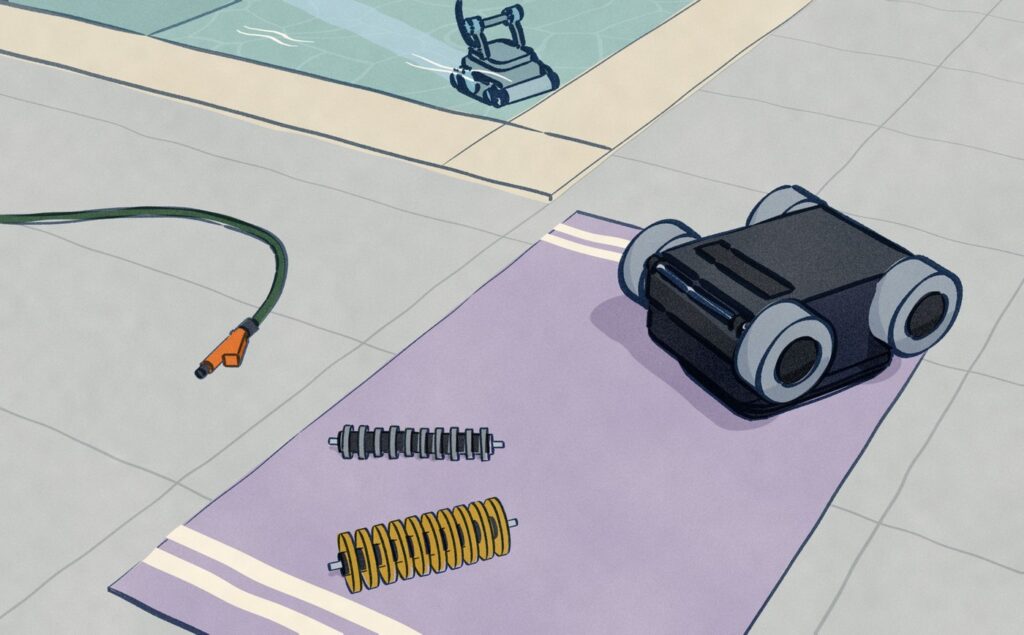 On the deck beside a gunite pool, a Polaris Alpha iQ+ lies on its back on a towel with its front brush taken off; the worn brush with its blades rubbed short lies beside a new one with tall blades.