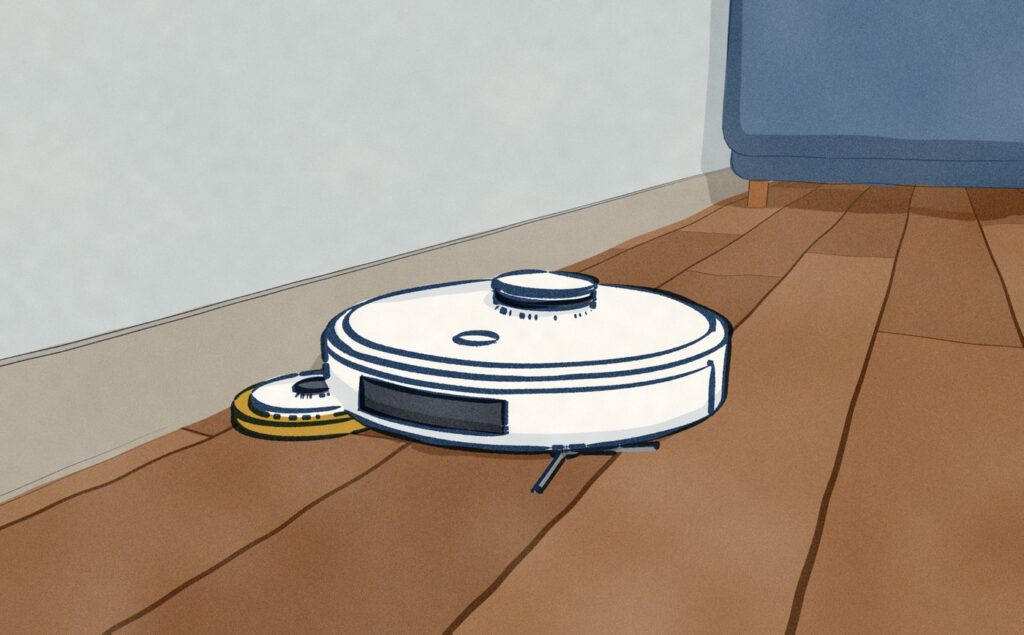 Close at the foot of a living room wall, a white Roborock Qrevo 2 Pro mops along the skirting with one mop pad swung out on a short arm past its round body, into the edge the body cannot reach.