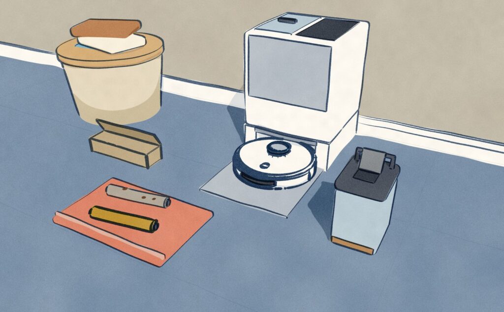 A white robot sits in its white dock with a silver upper panel; the used-water tank stands emptied on the floor beside it with its lid off, and in front on a folded towel an old grey roller lies beside a new one.